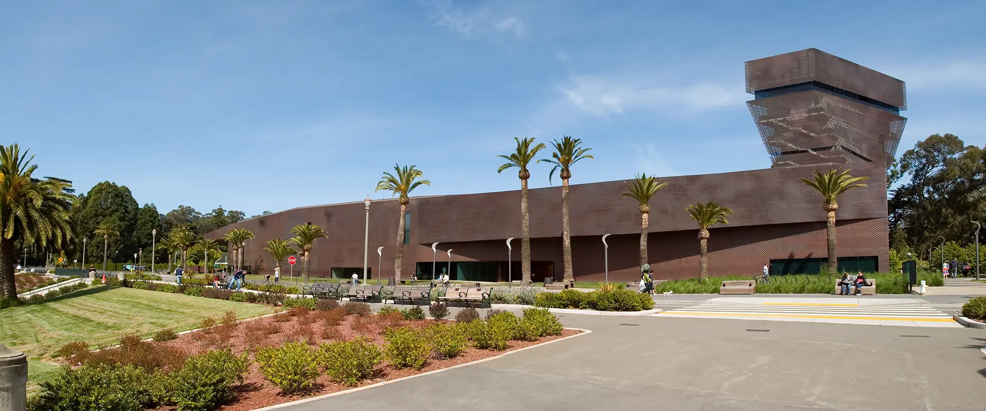 a brown building with people walking around in front of it